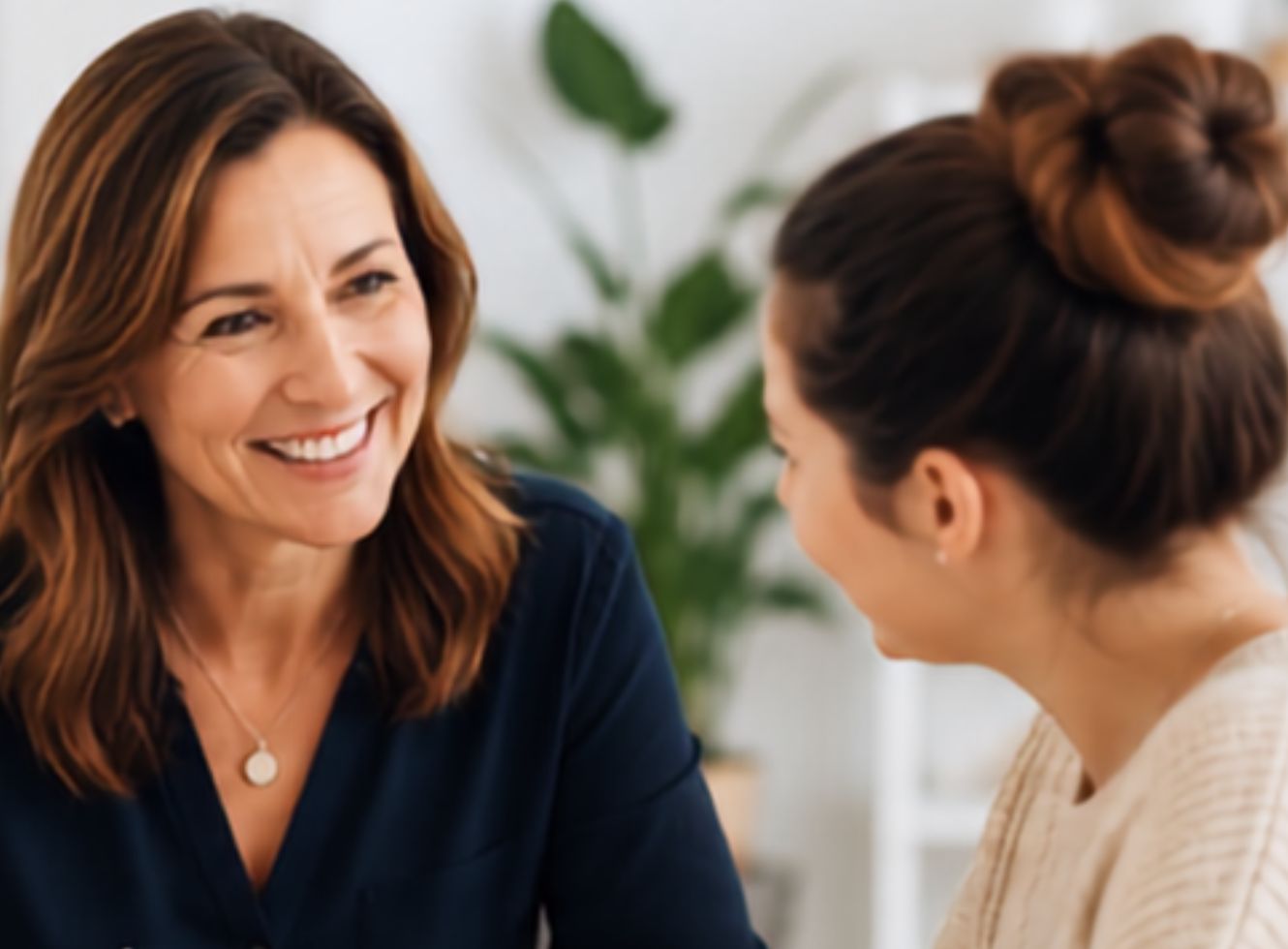 A clinical supervisor smiling during a one-to-one session